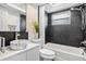Elegant bathroom featuring a marble sink, a large soaking tub with black tile, and modern fixtures at 3019 Park N St, St Petersburg, FL 33710