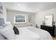 Bright bedroom with a large window, white bedding, and simple modern decor at 3019 Park N St, St Petersburg, FL 33710