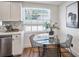 Kitchen dining area with a glass-top table, wire chairs, and views of the fenced backyard at 3019 Park N St, St Petersburg, FL 33710