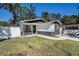 Inviting home featuring a well-kept lawn, modern black and white paint, and a paved walkway at 3019 Park N St, St Petersburg, FL 33710