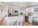Eat-in kitchen features white cabinets, stainless steel appliances, and a marble-top island at 3019 Park N St, St Petersburg, FL 33710