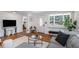Comfortable living room showcases hardwood floors, a cozy couch, and lots of natural light at 3019 Park N St, St Petersburg, FL 33710