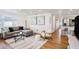 Comfortable living room showcasing hardwood floors, neutral decor, and an open layout to the kitchen at 3019 Park N St, St Petersburg, FL 33710