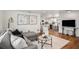 Modern living room with a comfortable gray sofa, stylish decor, and an open view to the kitchen at 3019 Park N St, St Petersburg, FL 33710
