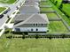 Aerial view of the home with a manicured backyard and tasteful landscaping at 34056 Scarlet Sage Ct, Wesley Chapel, FL 33545