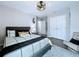 This cozy bedroom features a large bed, modern ceiling fan, and plenty of natural light at 34056 Scarlet Sage Ct, Wesley Chapel, FL 33545