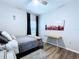 Neat bedroom featuring a neutral color scheme, desk, decorative art, and natural light at 34056 Scarlet Sage Ct, Wesley Chapel, FL 33545