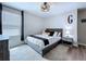 Bright bedroom with a stylish bed, herringbone rug, and natural light from the window at 34056 Scarlet Sage Ct, Wesley Chapel, FL 33545