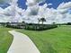 Scenic community walkway leading to amenities, surrounded by lush greenery and manicured landscaping at 34056 Scarlet Sage Ct, Wesley Chapel, FL 33545