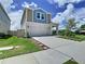 Charming two-story home with a well-manicured lawn and driveway at 34056 Scarlet Sage Ct, Wesley Chapel, FL 33545