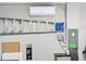 Organized garage featuring a ladder, AC unit, worktable, circuit breaker, and mini-fridge at 34056 Scarlet Sage Ct, Wesley Chapel, FL 33545