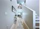 Elegant hallway features hardwood floors, stylish decor, and a view into the dining and living areas at 34056 Scarlet Sage Ct, Wesley Chapel, FL 33545
