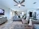 Comfortable living room features a large sectional, open layout, and seamless flow to the dining and kitchen at 34056 Scarlet Sage Ct, Wesley Chapel, FL 33545
