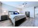 Cozy main bedroom with dark furnishings, stylish decor, and a comfortable bed at 34056 Scarlet Sage Ct, Wesley Chapel, FL 33545