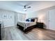 Well-lit main bedroom with dark furnishings, stylish decor, and a comfortable bed at 34056 Scarlet Sage Ct, Wesley Chapel, FL 33545