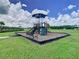 Community playground featuring slides, climbing structures, and shaded seating areas, perfect for outdoor fun and recreation at 34056 Scarlet Sage Ct, Wesley Chapel, FL 33545
