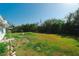 View of a large backyard space surrounded by mature trees and bordered by a fence at 3614 Vasco St, Punta Gorda, FL 33950