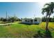 Charming single-story home with a well-manicured lawn and a large tree at 3614 Vasco St, Punta Gorda, FL 33950