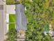 An aerial view highlighting the property's layout, lush landscaping, and sparkling blue pool, near mature trees at 4019 W Bay To Bay Blvd, Tampa, FL 33629