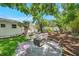 Serene backyard with a fire pit and chairs, ideal for relaxing and entertaining guests at 4019 W Bay To Bay Blvd, Tampa, FL 33629
