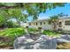 Charming backyard oasis with a fire pit, comfortable seating, and lush greenery at 4019 W Bay To Bay Blvd, Tampa, FL 33629