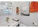 Bright bathroom featuring modern fixtures, a white vanity, and an eye-catching car art print at 4019 W Bay To Bay Blvd, Tampa, FL 33629