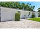 Paver driveway leading to a white home with an attached garage and manicured landscaping at 4019 W Bay To Bay Blvd, Tampa, FL 33629