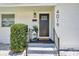 Charming front door with black hardware, a welcome mat, and decorative plants at 4019 W Bay To Bay Blvd, Tampa, FL 33629