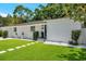 Well-maintained front yard with lush green grass, white rock accents, and manicured landscaping at 4019 W Bay To Bay Blvd, Tampa, FL 33629