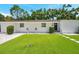 Inviting home exterior with lush green lawn, stepping stones, and manicured shrubbery at 4019 W Bay To Bay Blvd, Tampa, FL 33629