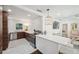 Open-concept kitchen featuring stainless steel appliances, white countertops, and dark wood cabinets at 4019 W Bay To Bay Blvd, Tampa, FL 33629