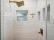 Clean glass shower with white subway tile, gold fixtures, and a built-in niche at 4019 W Bay To Bay Blvd, Tampa, FL 33629