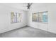 A bedroom with two windows and a ceiling fan provides natural light and air flow at 410 73Rd Ave, St Pete Beach, FL 33706