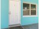Close-up of the front door highlighting the unit number and adjacent window at 410 73Rd Ave, St Pete Beach, FL 33706