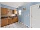 Functional kitchen with tile flooring, wood cabinets, and natural light, offering practicality and potential at 410 73Rd Ave, St Pete Beach, FL 33706