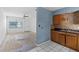 View of the kitchen area with tile flooring, wood cabinets, connected to a living room at 410 73Rd Ave, St Pete Beach, FL 33706