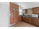 Cozy kitchen featuring a red brick wall and stainless steel appliances, and tiled floors at 410 73Rd Ave, St Pete Beach, FL 33706
