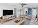 Modern living room with neutral furniture, stylish décor, and a ceiling fan, creating a comfortable space at 410 73Rd Ave, St Pete Beach, FL 33706