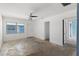 Empty living room, featuring natural light, white walls, ceiling fan and access to other rooms at 410 73Rd Ave, St Pete Beach, FL 33706