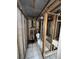 Bathroom remodel showcasing studs, plumbing, and a tiled floor with a toilet installed at 4129 Dolphin Dr # 103, Tampa, FL 33617