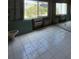 Under-construction bathroom featuring tiled floor, large window, and air conditioning unit at 4129 Dolphin Dr # 103, Tampa, FL 33617
