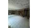 Bathroom showing damage, studs, tile floor, and large mirrors, requiring renovation at 4129 Dolphin Dr # 103, Tampa, FL 33617