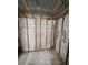 Exposed framing of bathroom remodel; concrete walls, exposed rafters, and tiled floors at 4129 Dolphin Dr # 103, Tampa, FL 33617