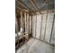 Bathroom under renovation with exposed framing, block walls, tiled floor, and visible plumbing at 4129 Dolphin Dr # 103, Tampa, FL 33617