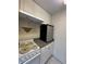 Kitchen featuring white appliances, cabinets, and tile flooring at 4148 Dolphin Dr # 3, Tampa, FL 33617
