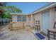 Cozy backyard featuring neutral color brick facade, work bench, and outdoor seating for a relaxing retreat at 4150 Woodsville Dr, New Port Richey, FL 34652