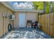 Small backyard patio with grill, storage, fenced in area and extra storage space at 4150 Woodsville Dr, New Port Richey, FL 34652