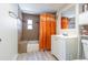 Well-maintained bathroom featuring a shower-tub combination, with a white vanity and sink, illuminated by natural light at 4150 Woodsville Dr, New Port Richey, FL 34652