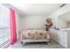 Bright bedroom featuring wood-look floors, a dresser, and a window with pink curtains at 4150 Woodsville Dr, New Port Richey, FL 34652