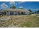Attractive single-story home with a covered front porch, complete with an attached garage and well-maintained lawn at 4150 Woodsville Dr, New Port Richey, FL 34652